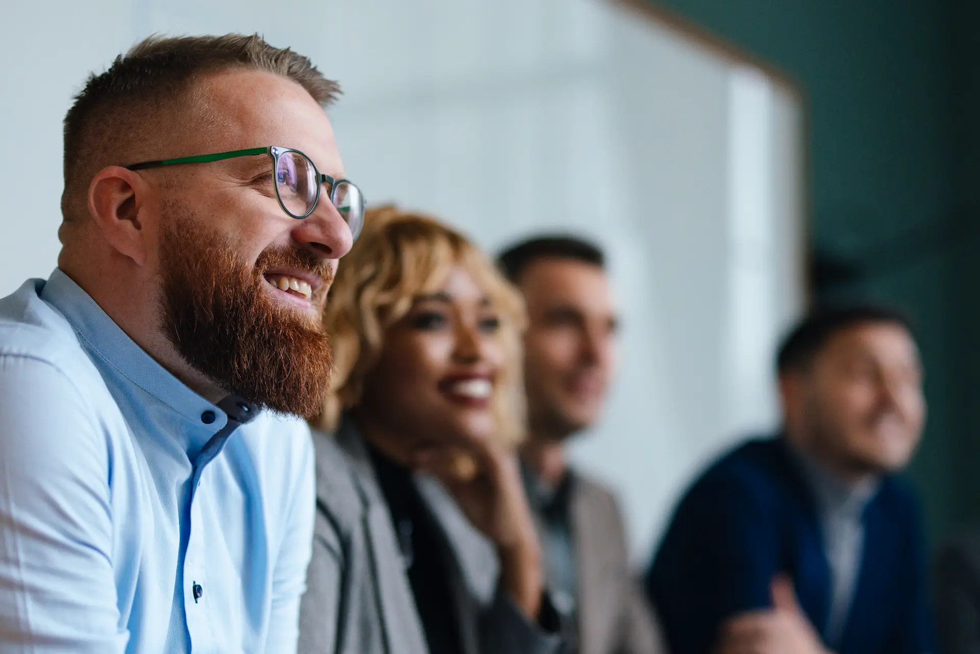 Businesspeople Listening To A Presentation In Their Office