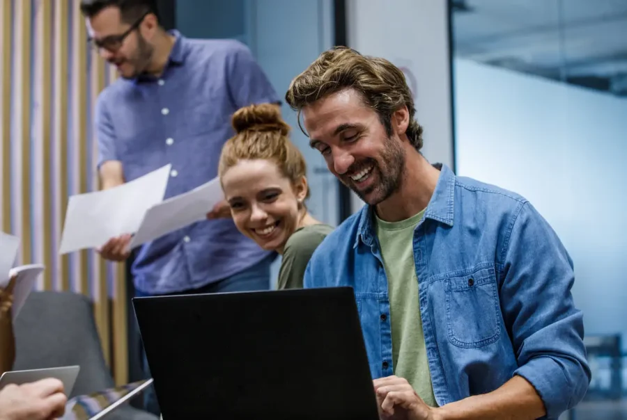 Cheerful coworkers successfully working on a project together